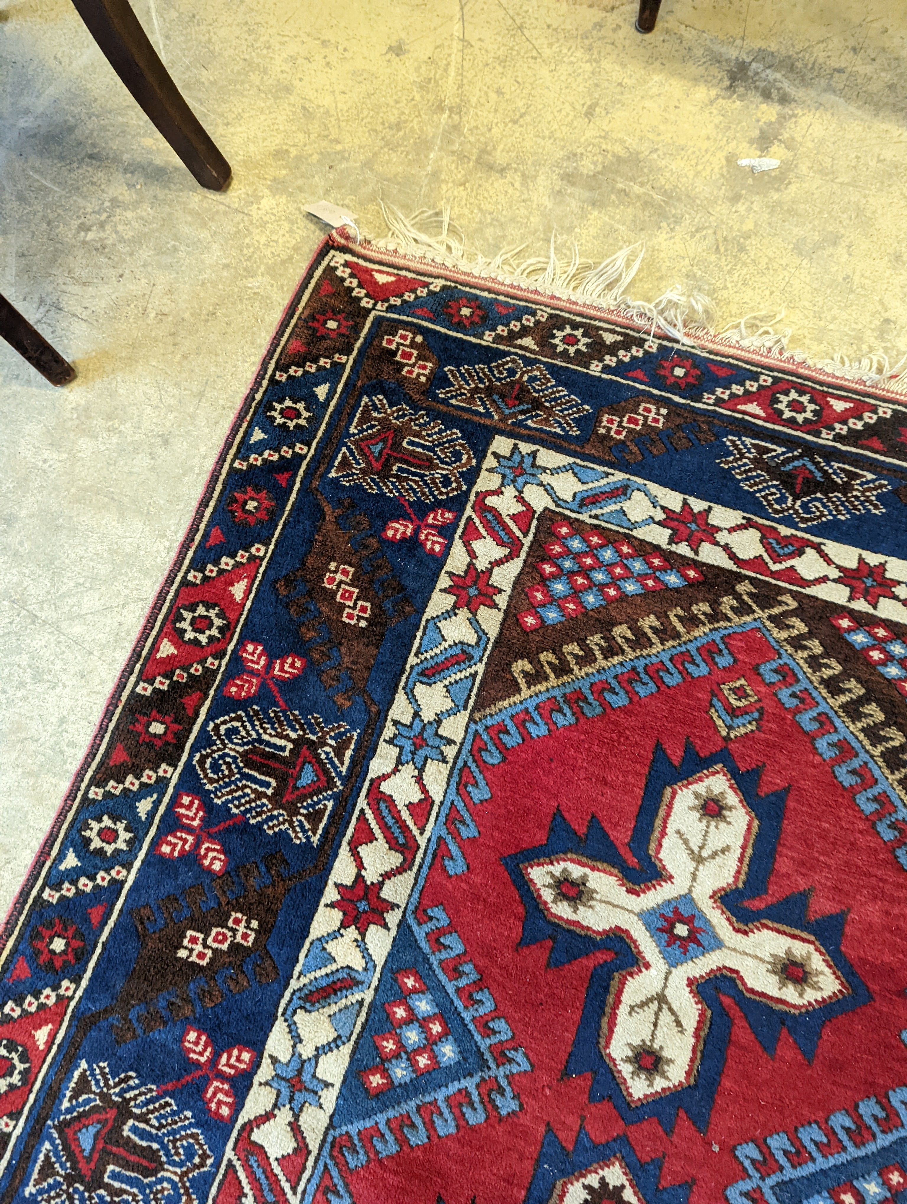A Caucasian red ground rug, 194 x 128cm